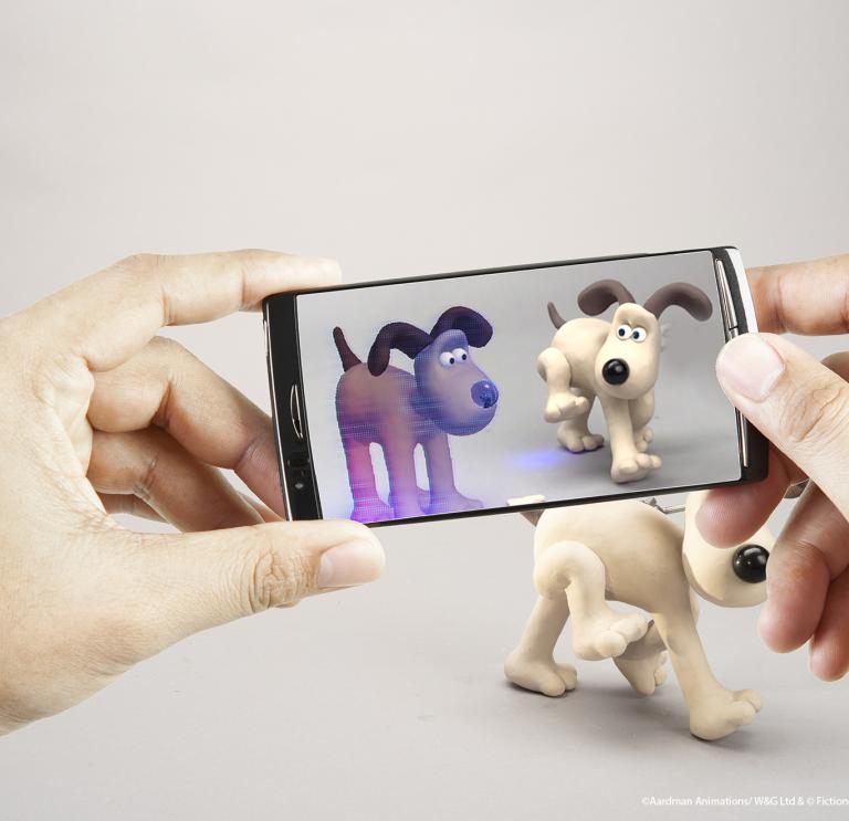 Close up of hands holding an iphone showcasing Gromit from Wallace Gromit