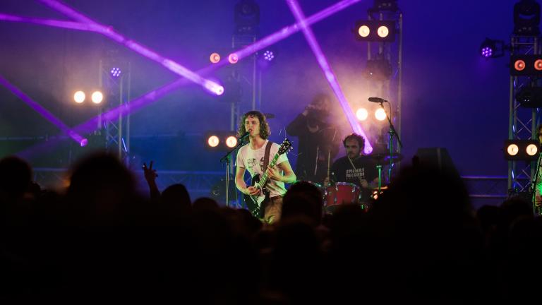 Shot of the lead singer from Buzzard Buzzard Buzzard, Tom performing on stage at Clwb Yn Y Castell (2021)