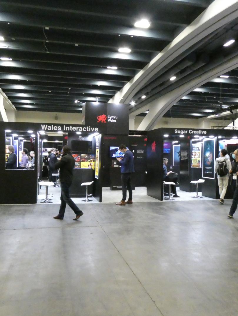 Wide shot of people browsing screens and stands at the Games Developer Conference