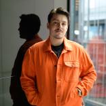 Charles Strider, a man in his twenties looks directly at the camera